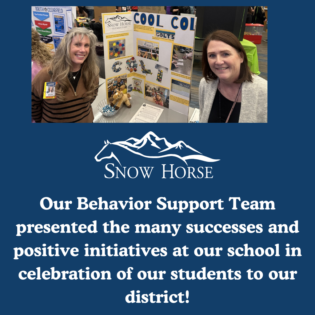 Two staff showing our display of programs at our school 