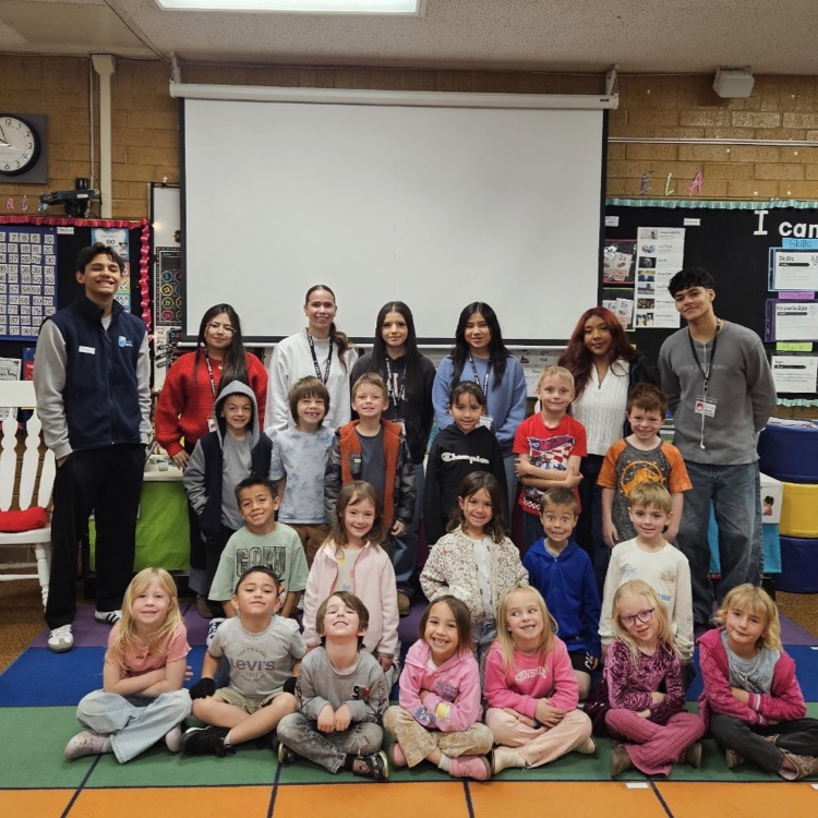 Latinos in Action from Layton High School working with kindergarteners on their reading. 