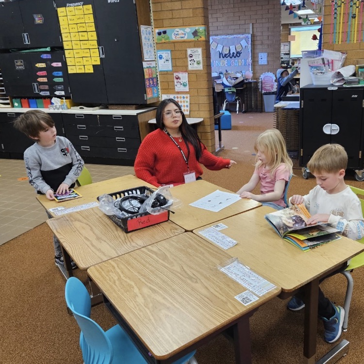 Latinos in Action from Layton High School working with kindergarteners on their reading. 