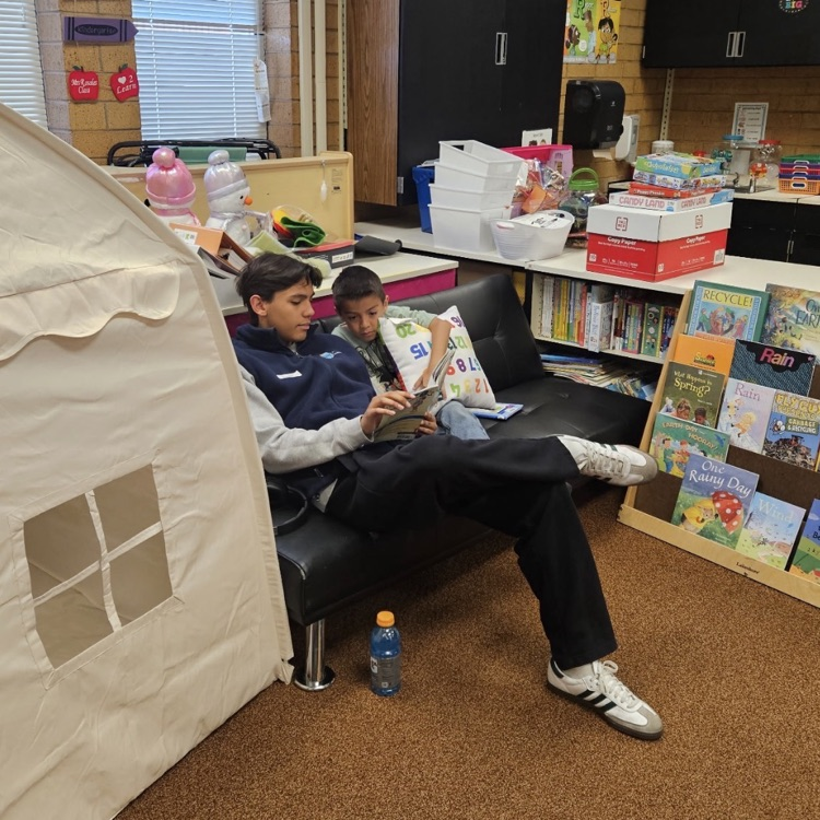 Latinos in Action from Layton High School working with kindergarteners on their reading. 