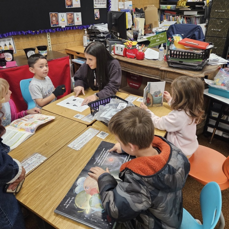Latinos in Action from Layton High School working with kindergarteners on their reading. 