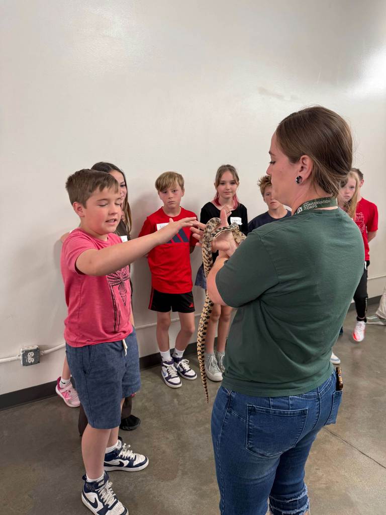 5th grade students observing a snake. 