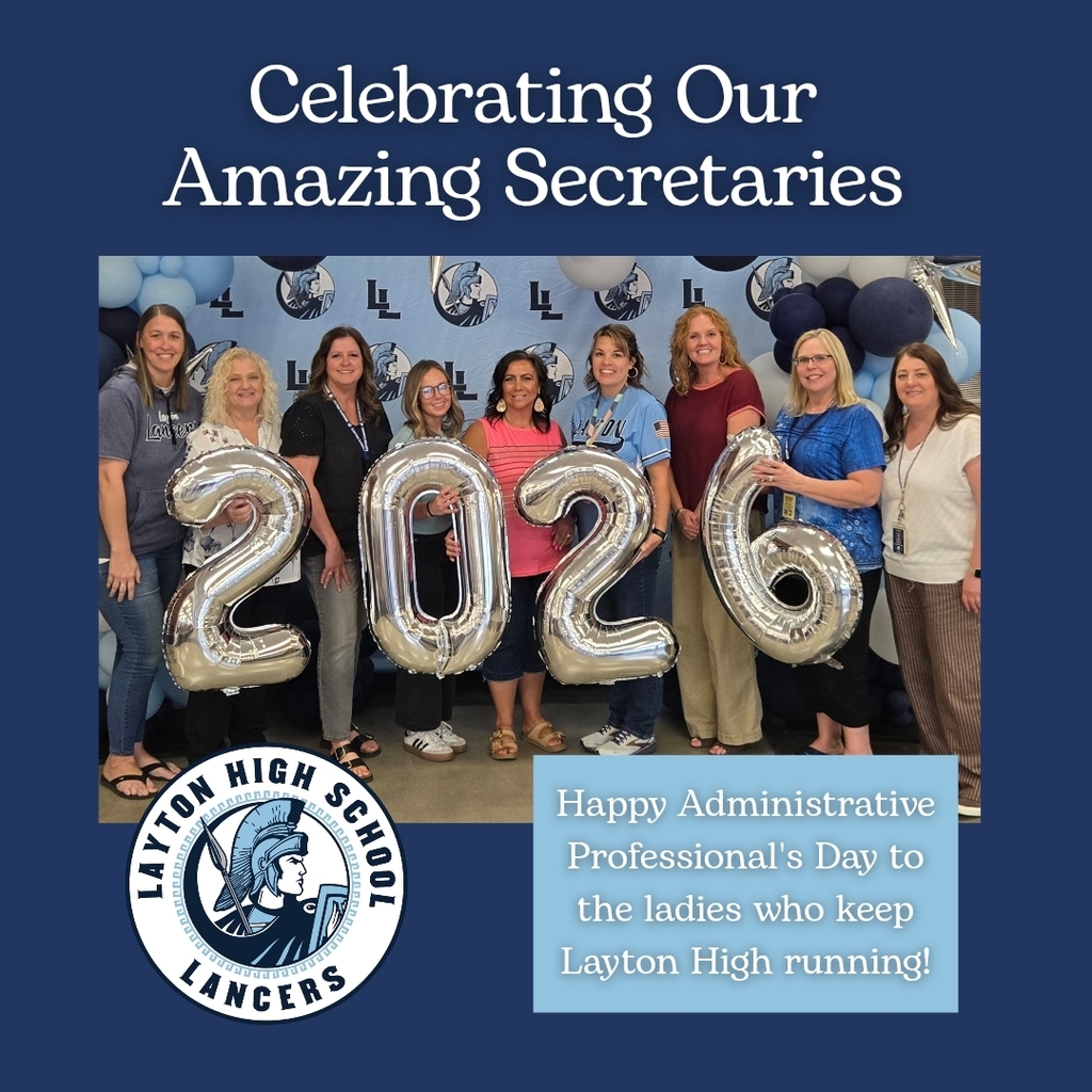 Picture showing layton high secretaries, standing in front of a backdrop and balloon arch, telling them thank you