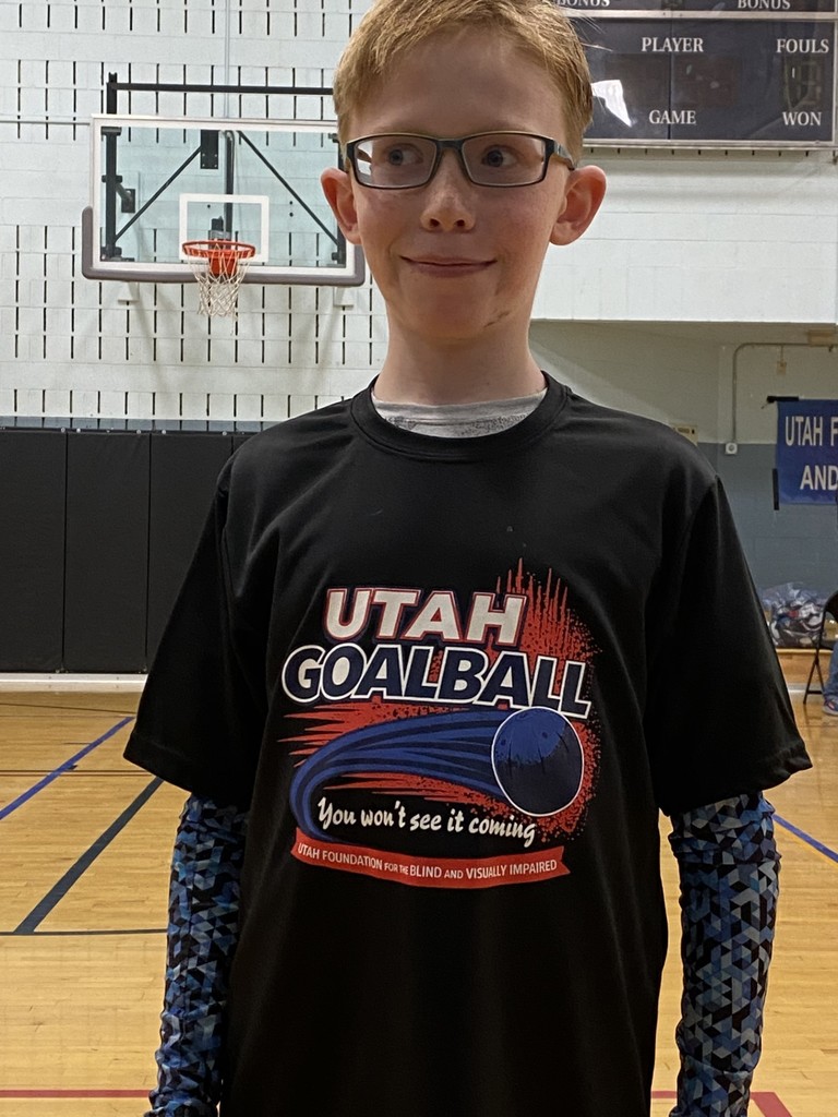 Student with goal ball t-shirt that says "Utah Goalball, you won't see it coming"