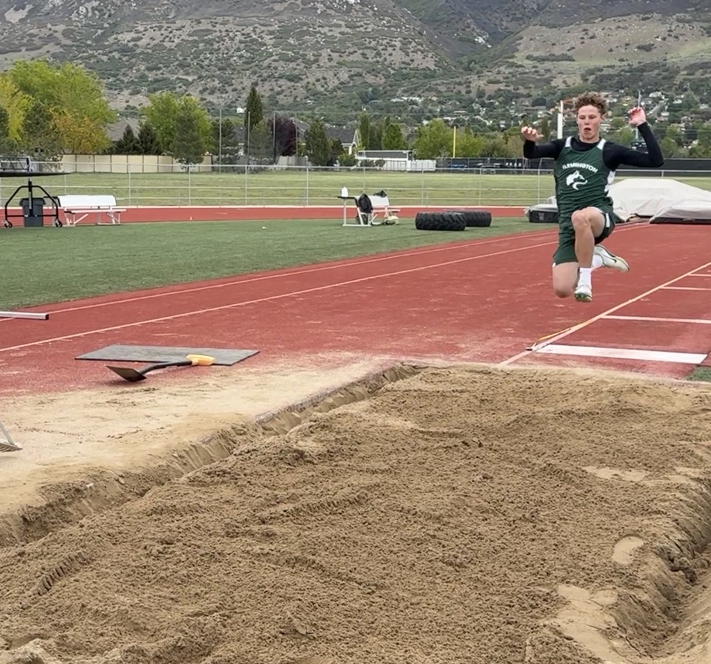 A student doing the long jump. 
