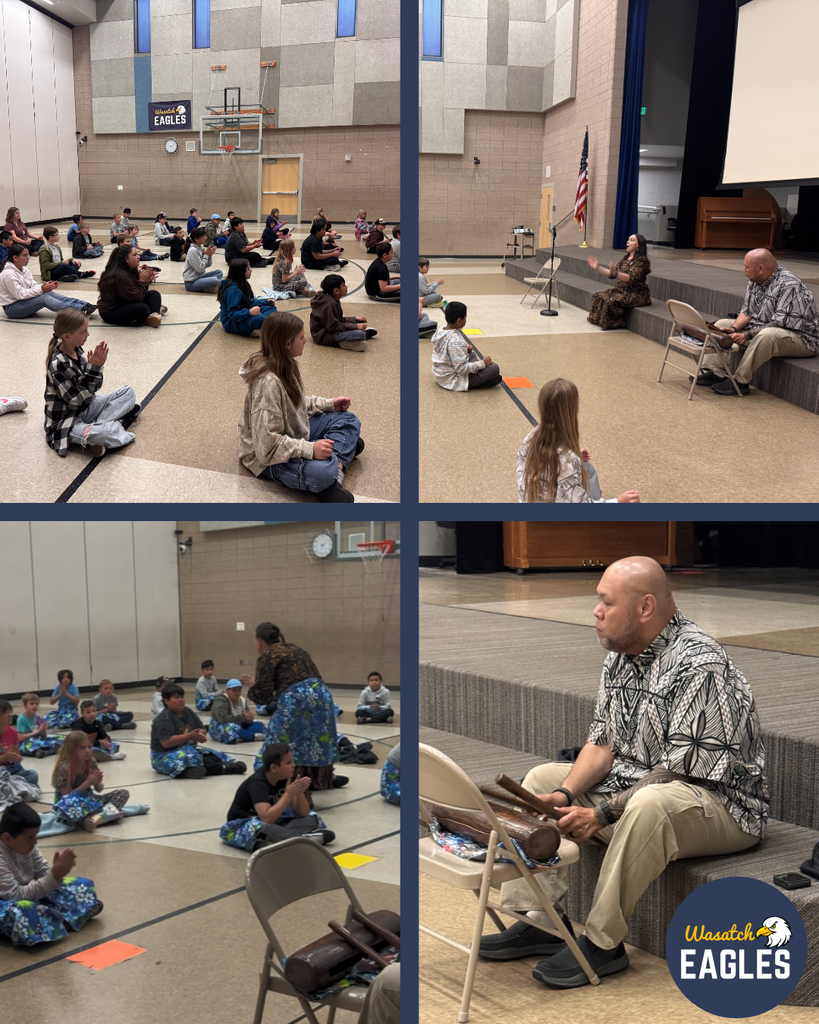 A four-photo collage shows elementary students seated on a gym floor during a school assembly. In the top images, students sit cross‑legged facing a low stage where an adult leads rhythmic clapping. In the bottom left image, an adult moves among students as they practice hand movements together. In the bottom right image, an adult sits on a chair beside the stage holding wooden percussion instruments. A school gym setting is visible with a basketball hoop, stage, chairs, and a “Wasatch Eagles” logo.