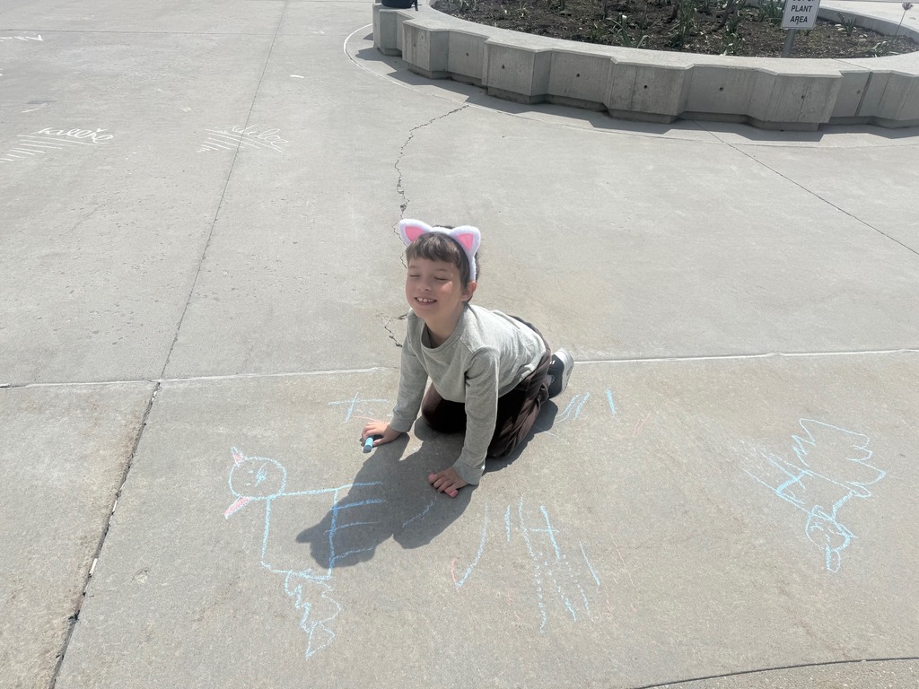 students pictured outside with their chalk art