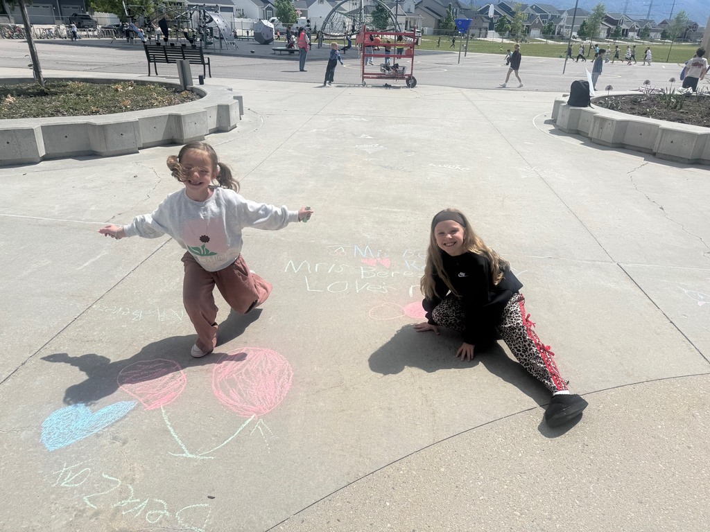 students pictured outside with their chalk art