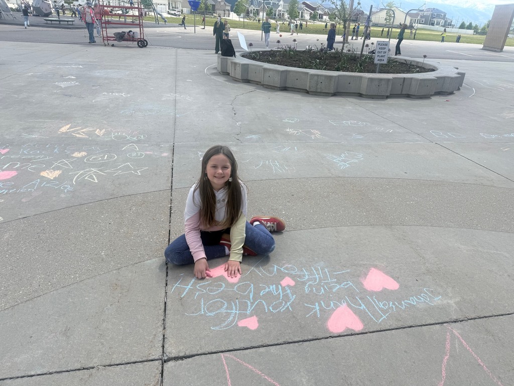 students pictured outside with their chalk art