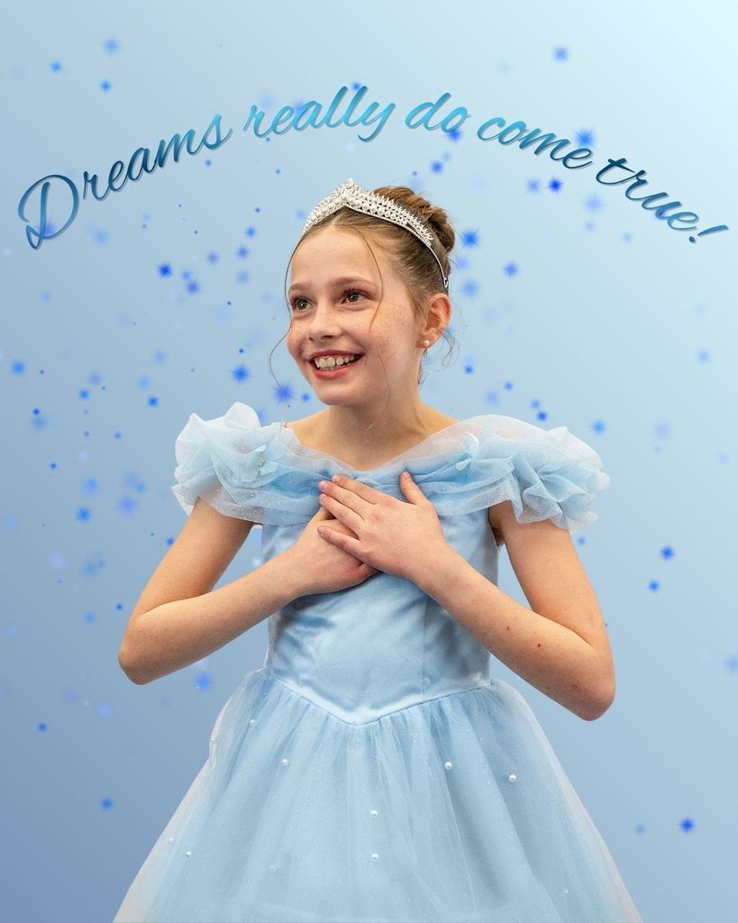 A student dressed as Cinderella from the musical stating above her "Dreams really do come true."