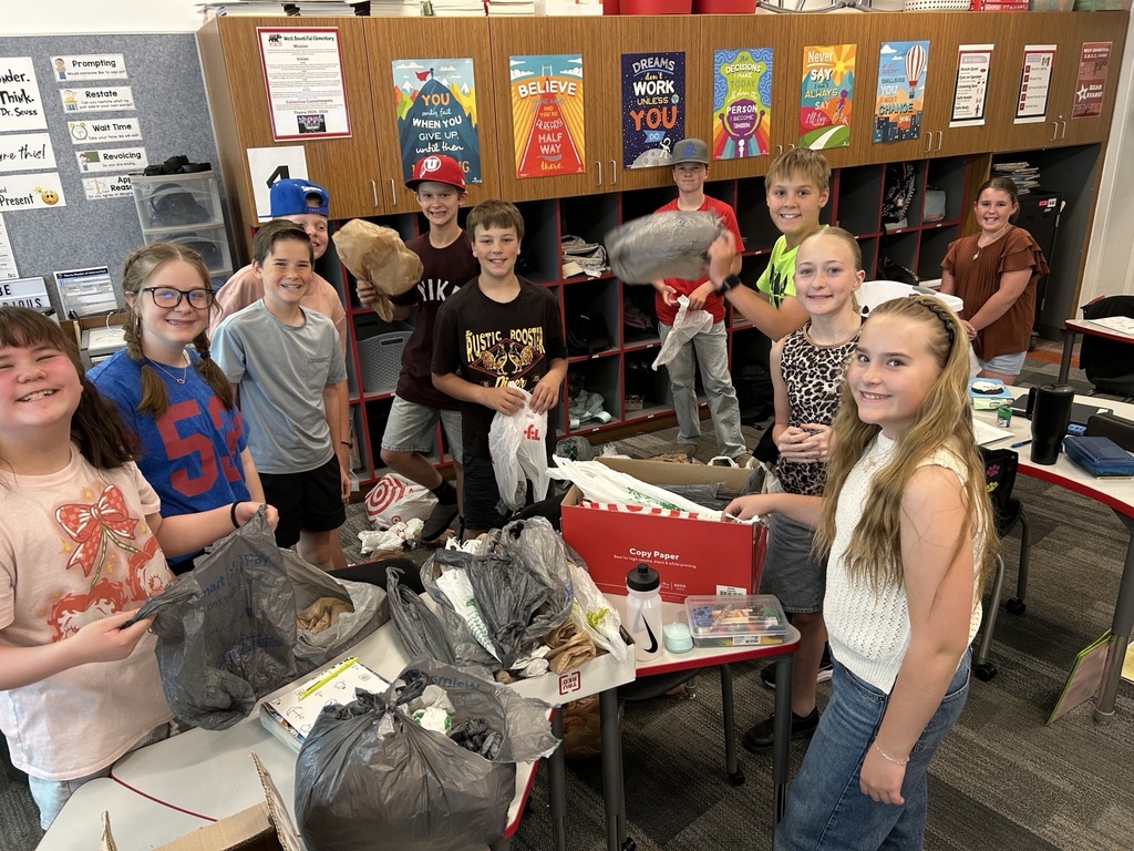 Students posing for a picture with all the grocery bags they collected. 