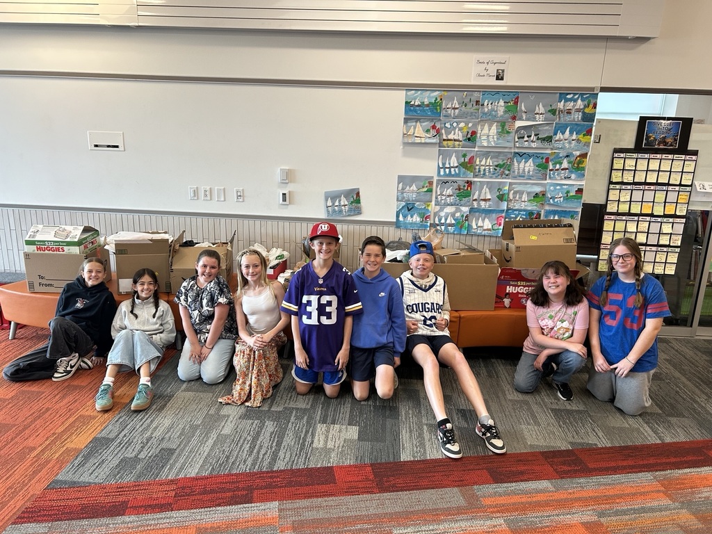 Students posing for a picture with all the grocery bags they collected. 
