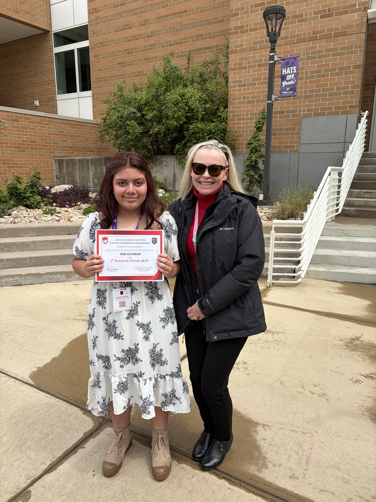 Student and Admin member standing together holding a certificate