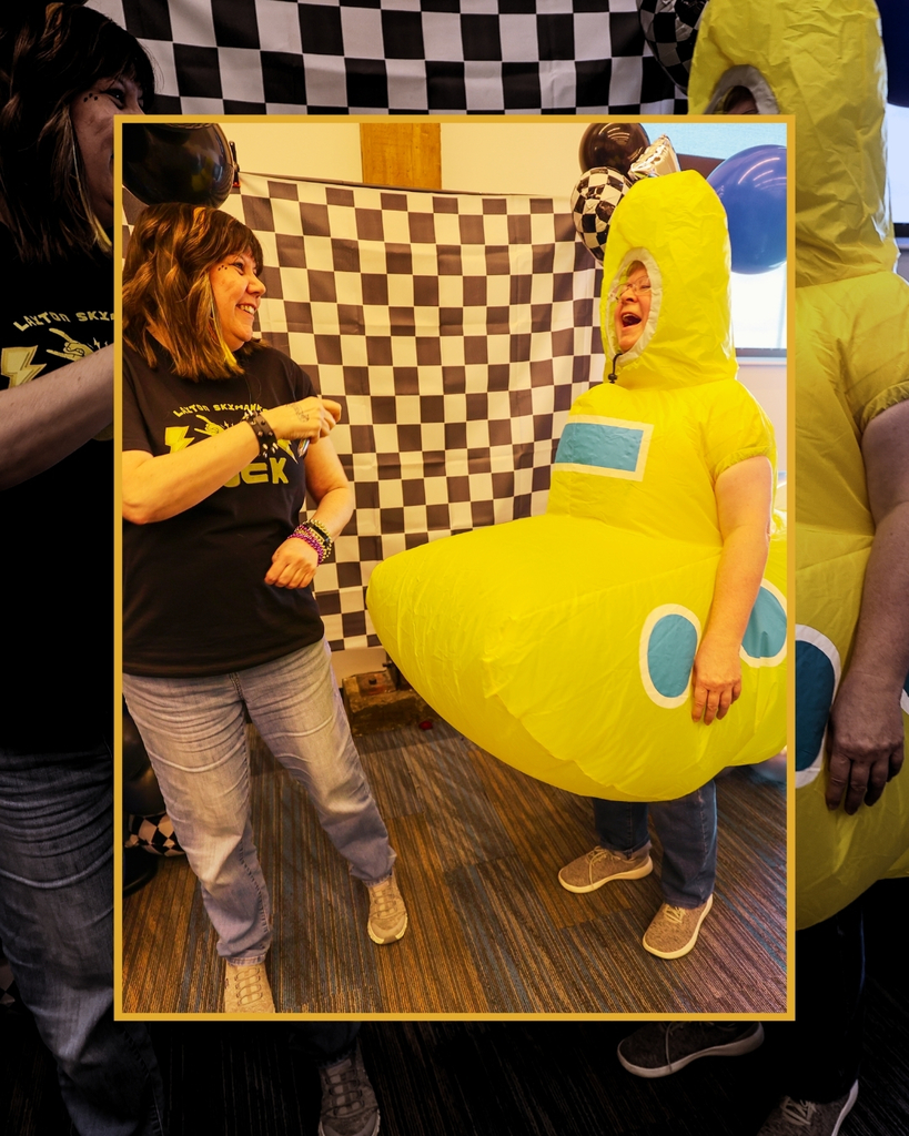 Someone in a yellow submarine costume laughs with someone next to them.