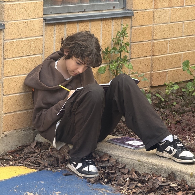 students working on their assignment outside 