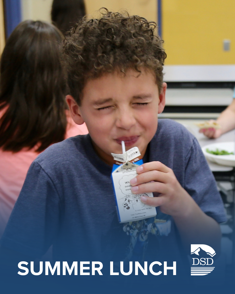 Student drinking chocolate milk with his eyes squeezed shut. 