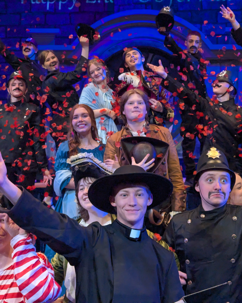 students posing in costume during final scene of Pirates of Penzance