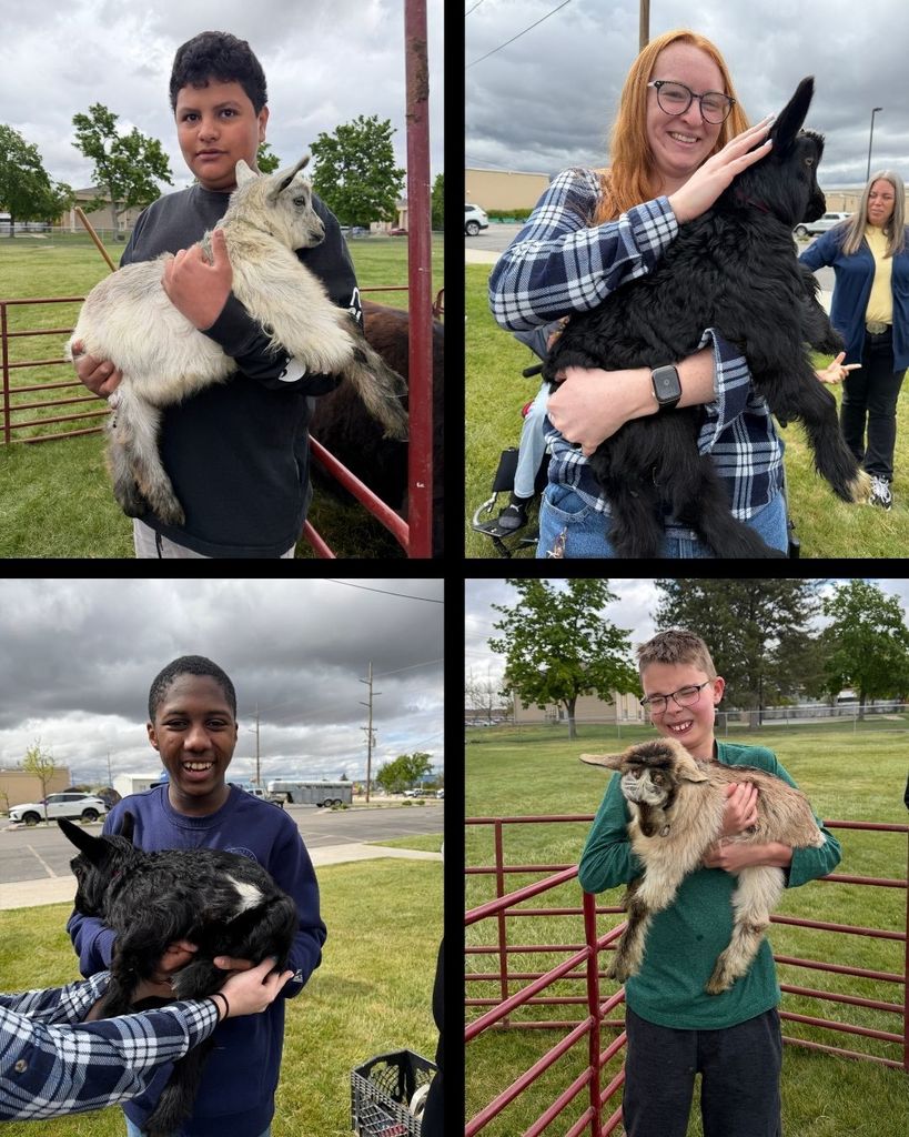 four students at NLJH holding baby goats