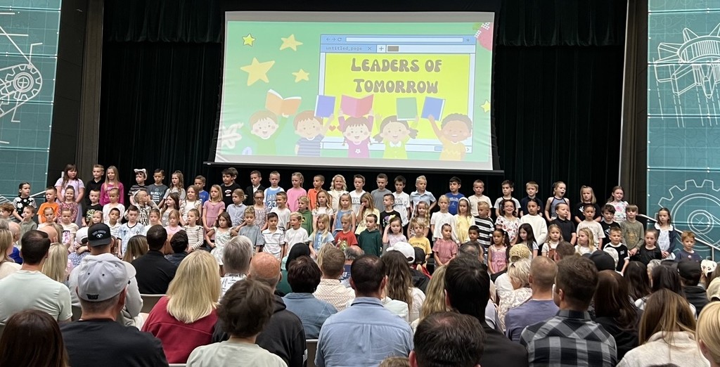 first grade students performing on the stage