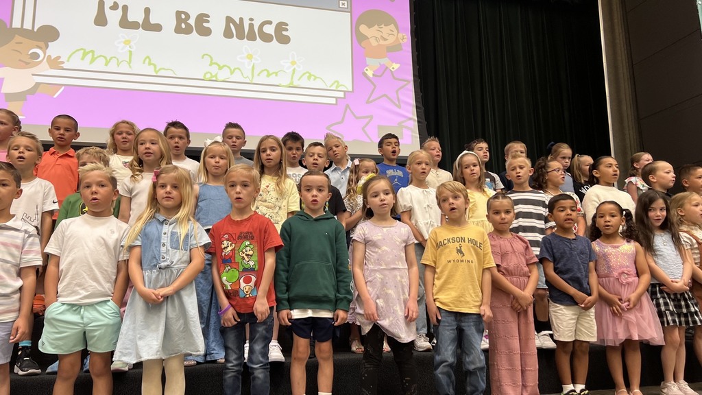 first grade students performing on the stage