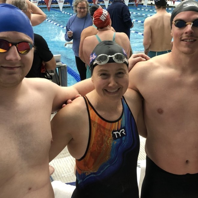 coach woodbury with other swimmers in front of a p