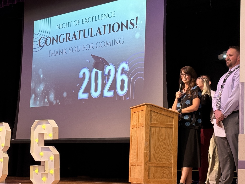 Night of Excellence Principal Standing with Microphone