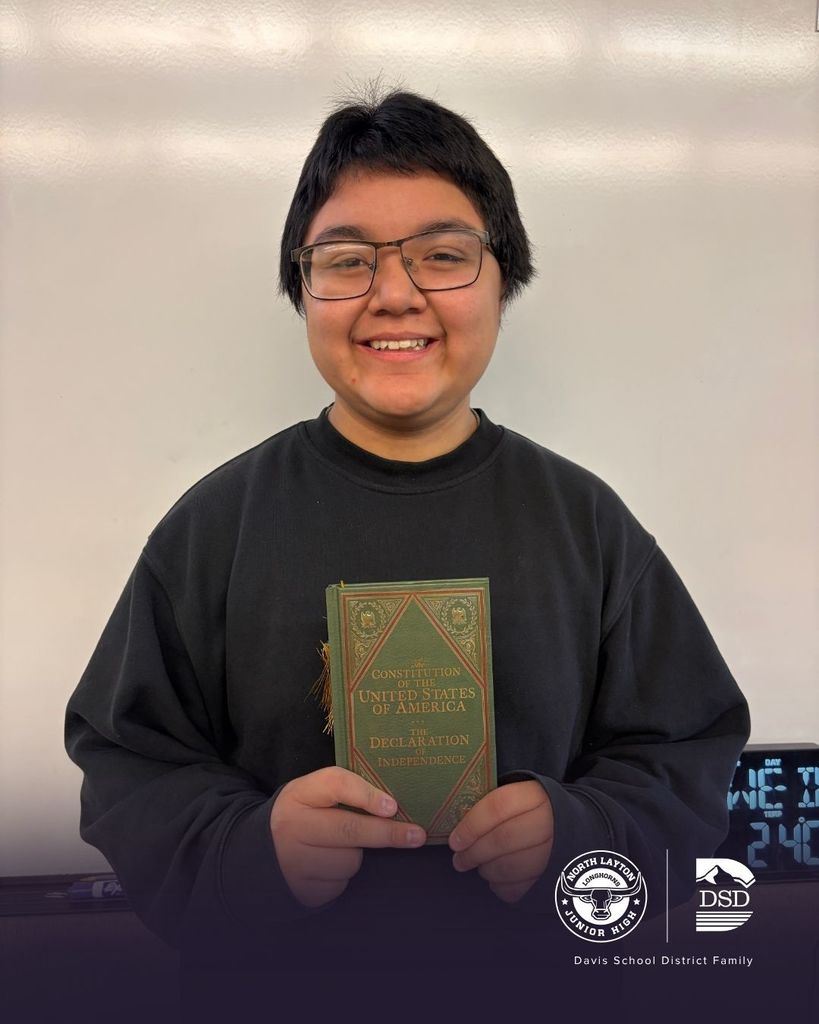 A North Layton Jr. High student holding a U.S. Constitution after speaking at a celebration of the 250 anniversary of the U.S. 