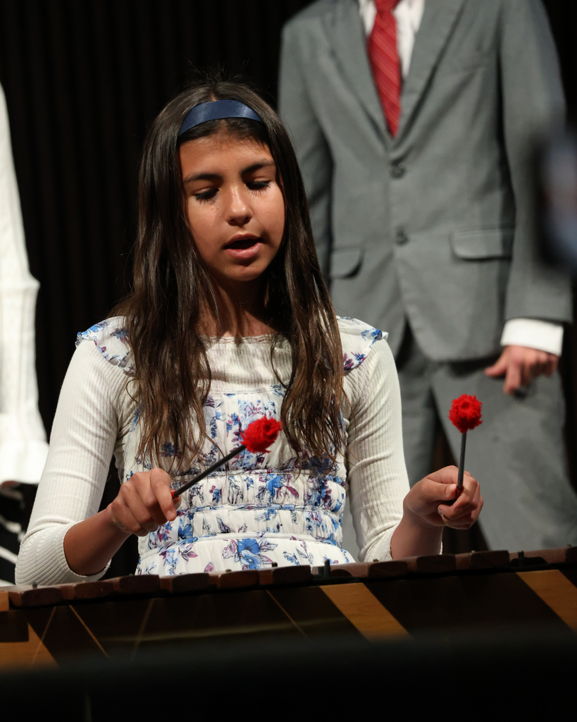 A student playing the xylophone singing.
