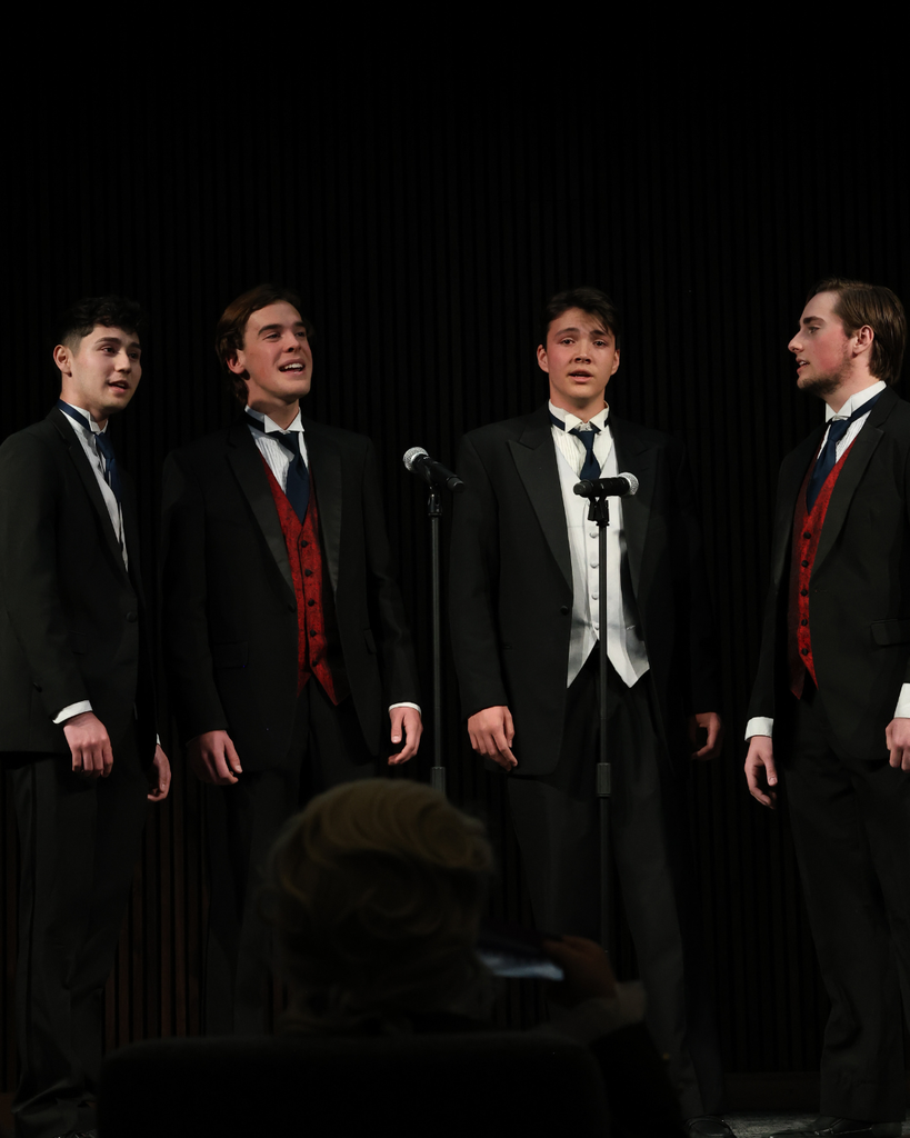 A student barber shop quartet singing. 