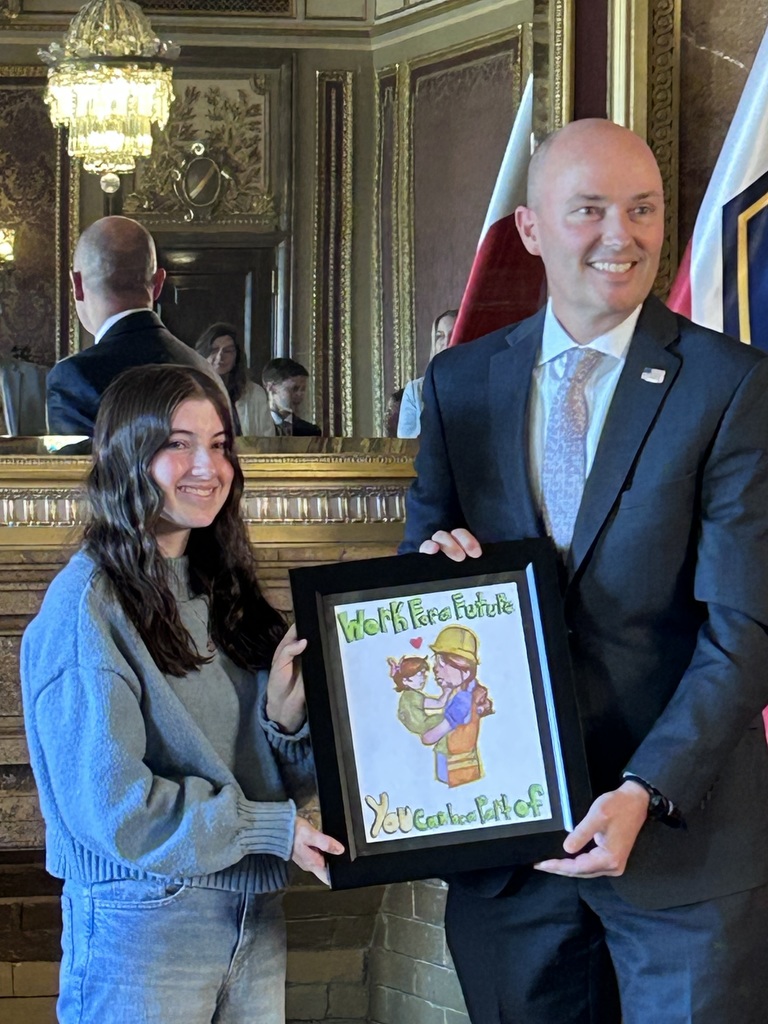 Picture of student with Governor Cox third place workplace safety contest.