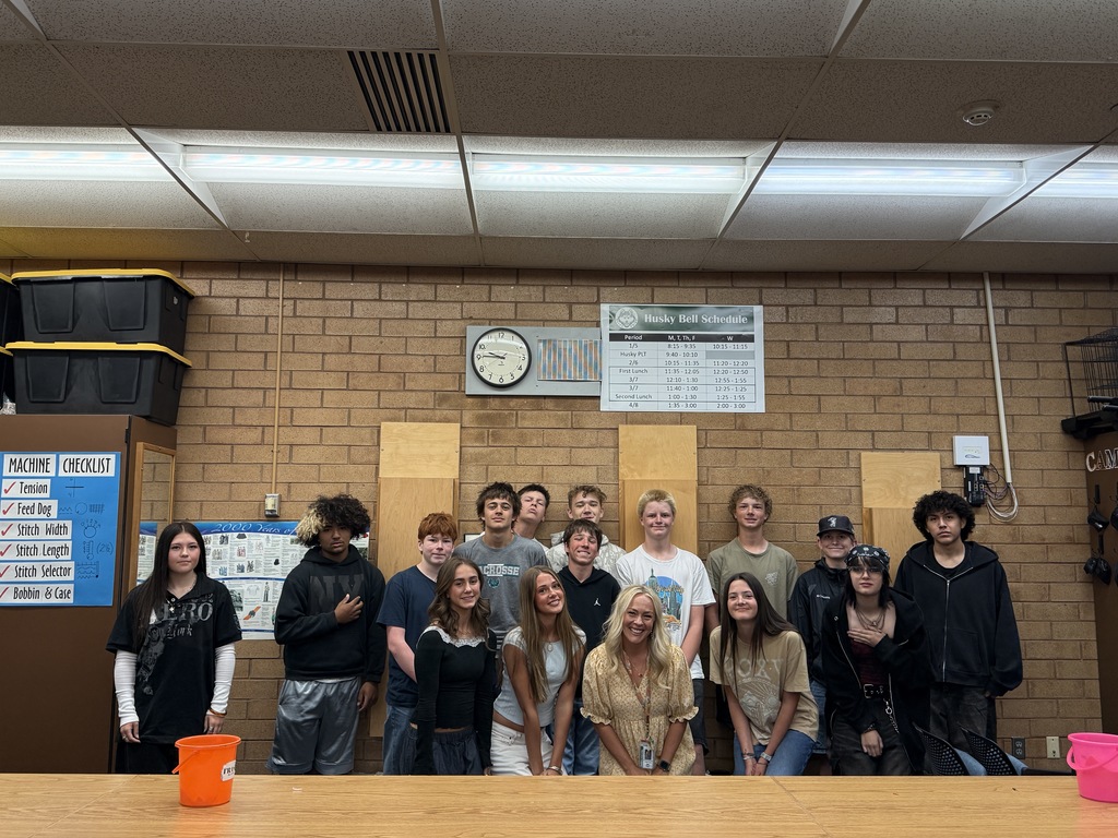 Students standing with Mrs. Sunderland. 