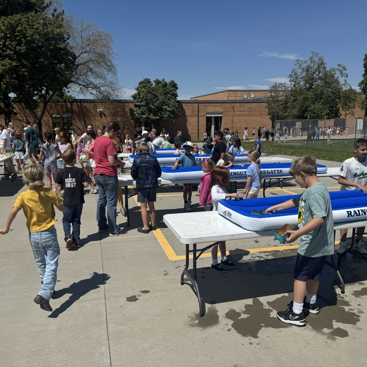 Students participating in a rain gutter regatta  