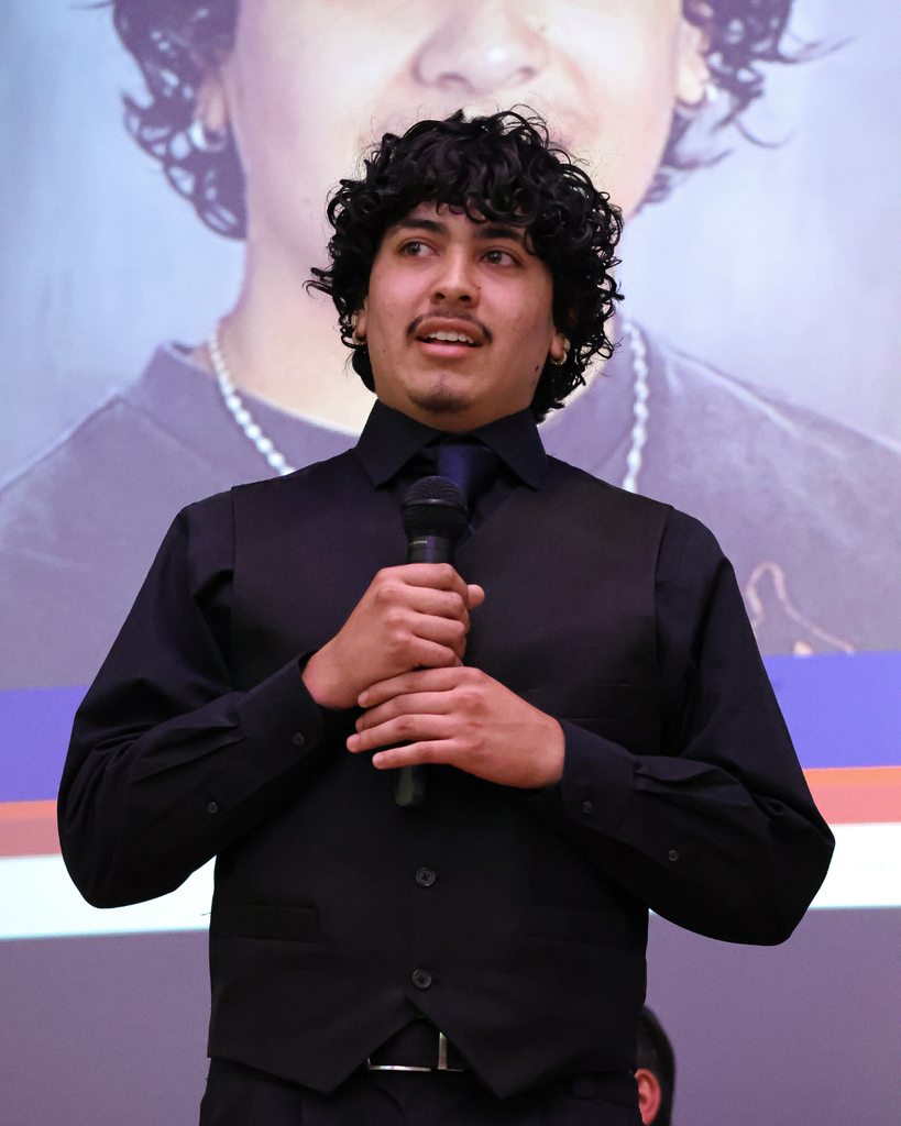 A student speaker speaking to the crowd.