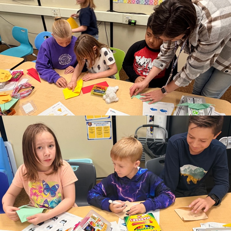 2nd graders working on origami creations with 6th graders