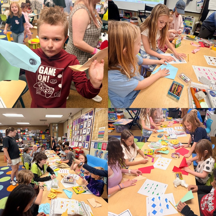 2nd graders working on origami creations with 6th graders