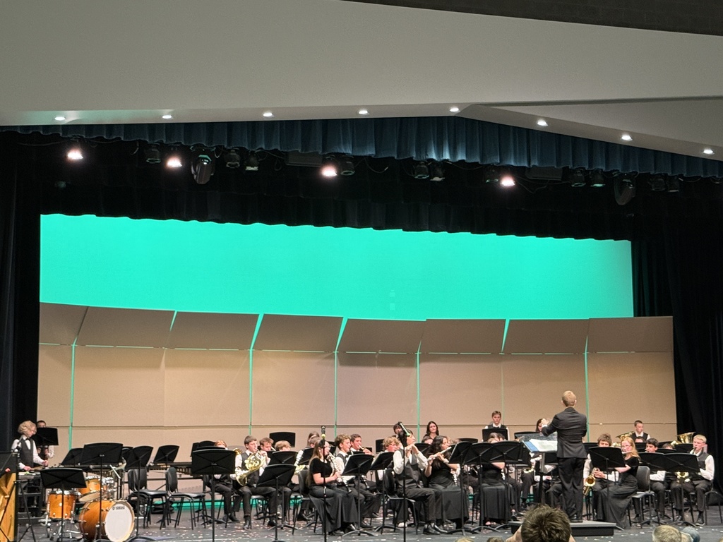 Symphonic band  performing  their final number. 
