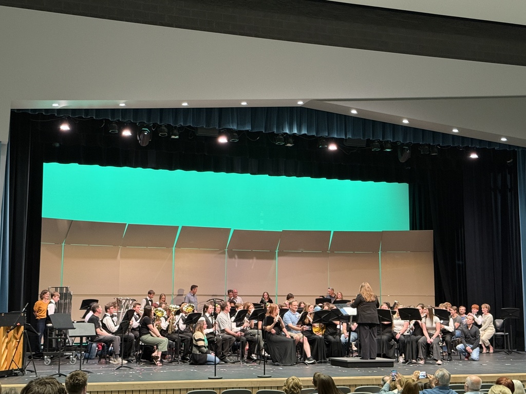 Honors band playing with their parents on stage. 