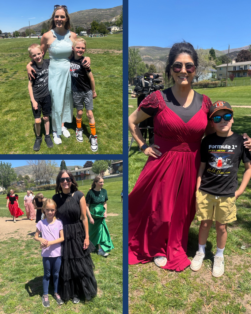 Moms in ball gowns posing with their students after a kickball game. 