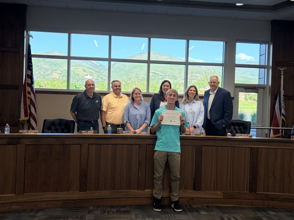 Student standing with his certificate during City Council