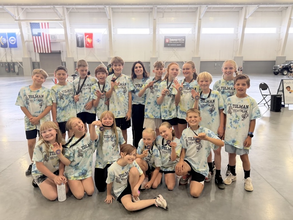 Decathlon Students with Mrs. Harvy holding their first place Medals. 