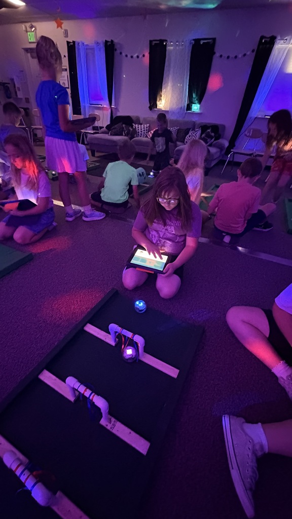 girl using ipad to control robot to go through spaces on golf course simulator