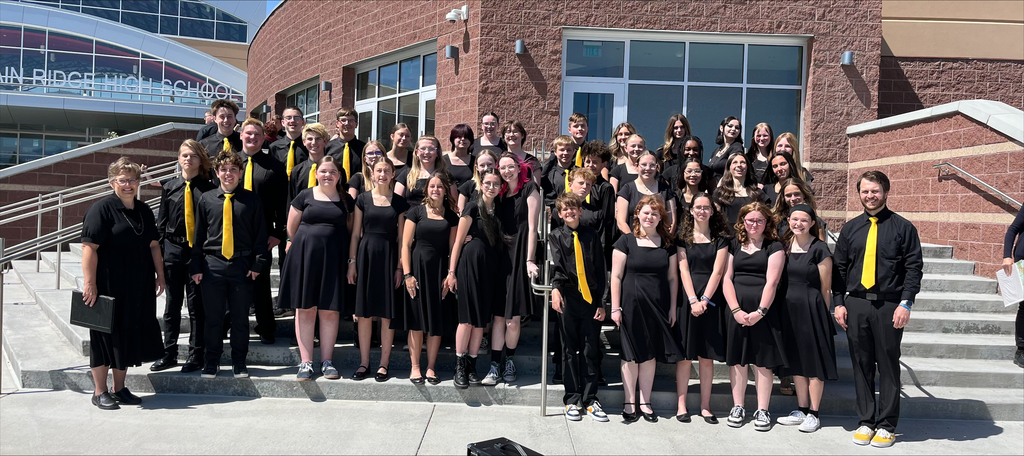 Solstice Choir posing on school steps.