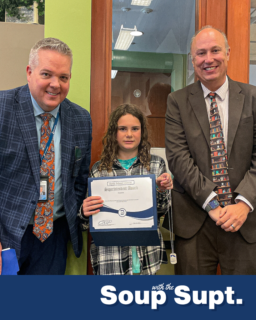 A student smiling with their principal and Dr. Linford, Davis School District Superintendent. 