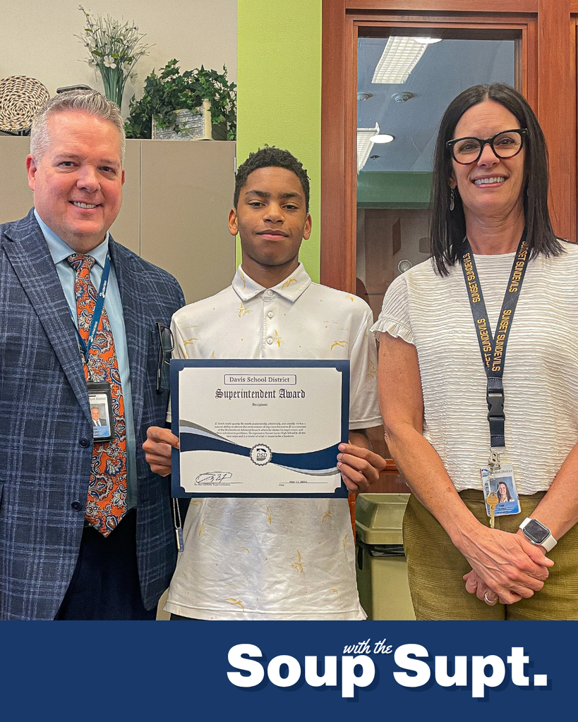 A student smiling with their principal and Dr. Linford, Davis School District Superintendent. 