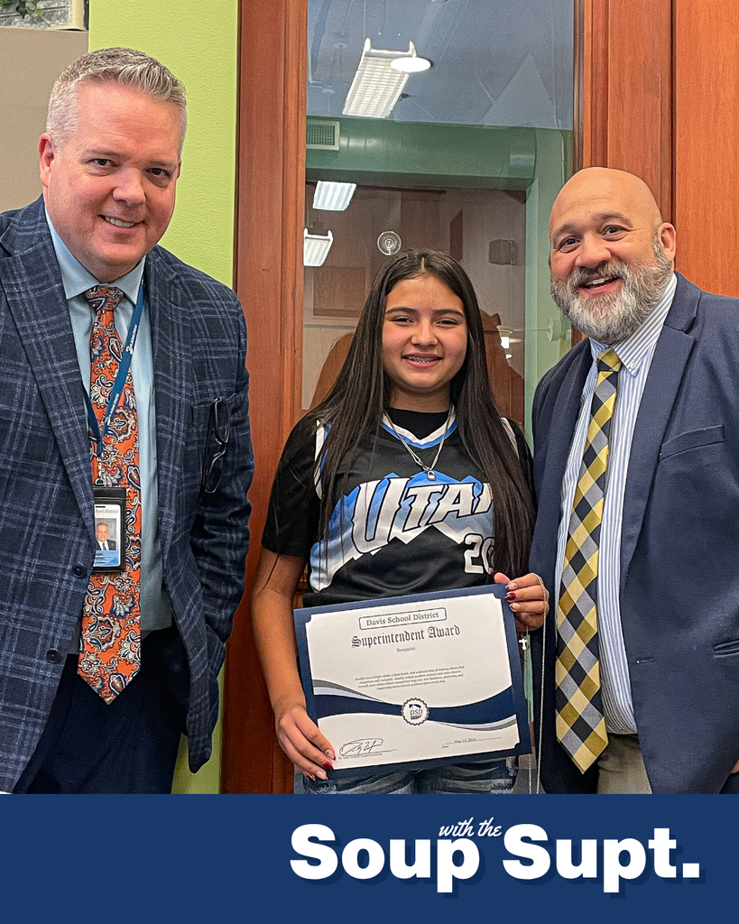A student smiling with their principal and Dr. Linford, Davis School District Superintendent. 