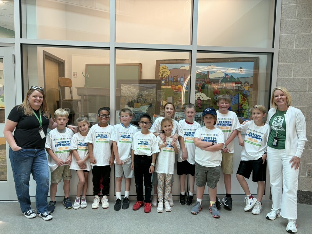 Bountiful Elementary perfect attendance students pose with two staff members in a school hallway before their celebratory lunch field trip to Arctic Circle.