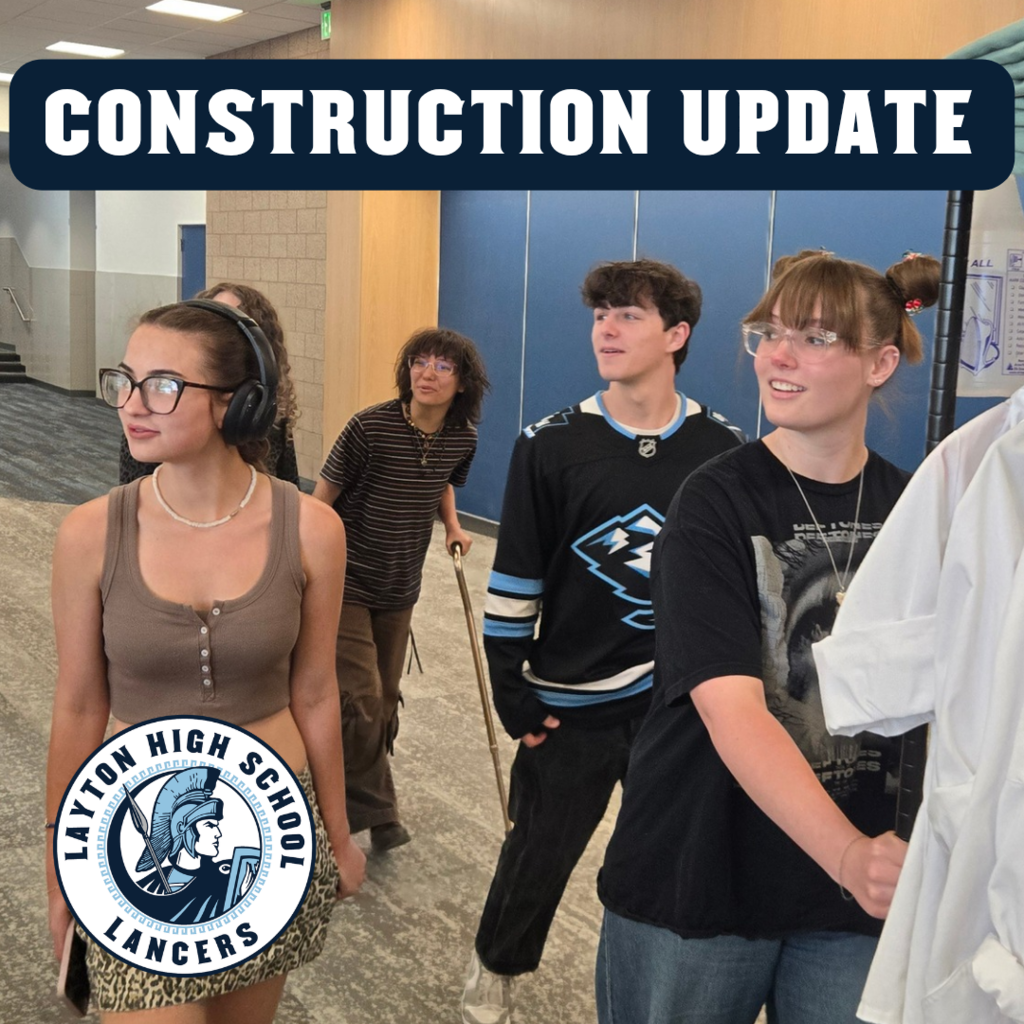 students looking in awe at the new construction as they move things in