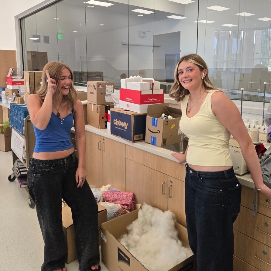 students excited in a new classroom after moving in boxes