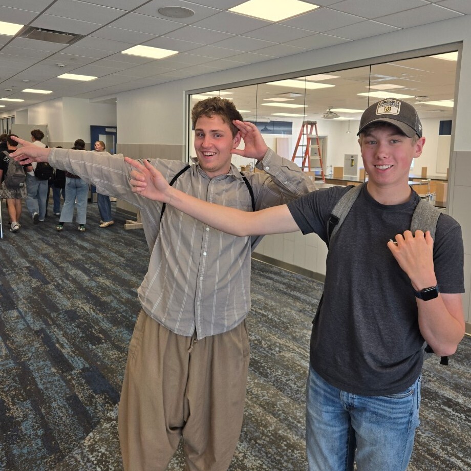 two students point with excitement at the new common area