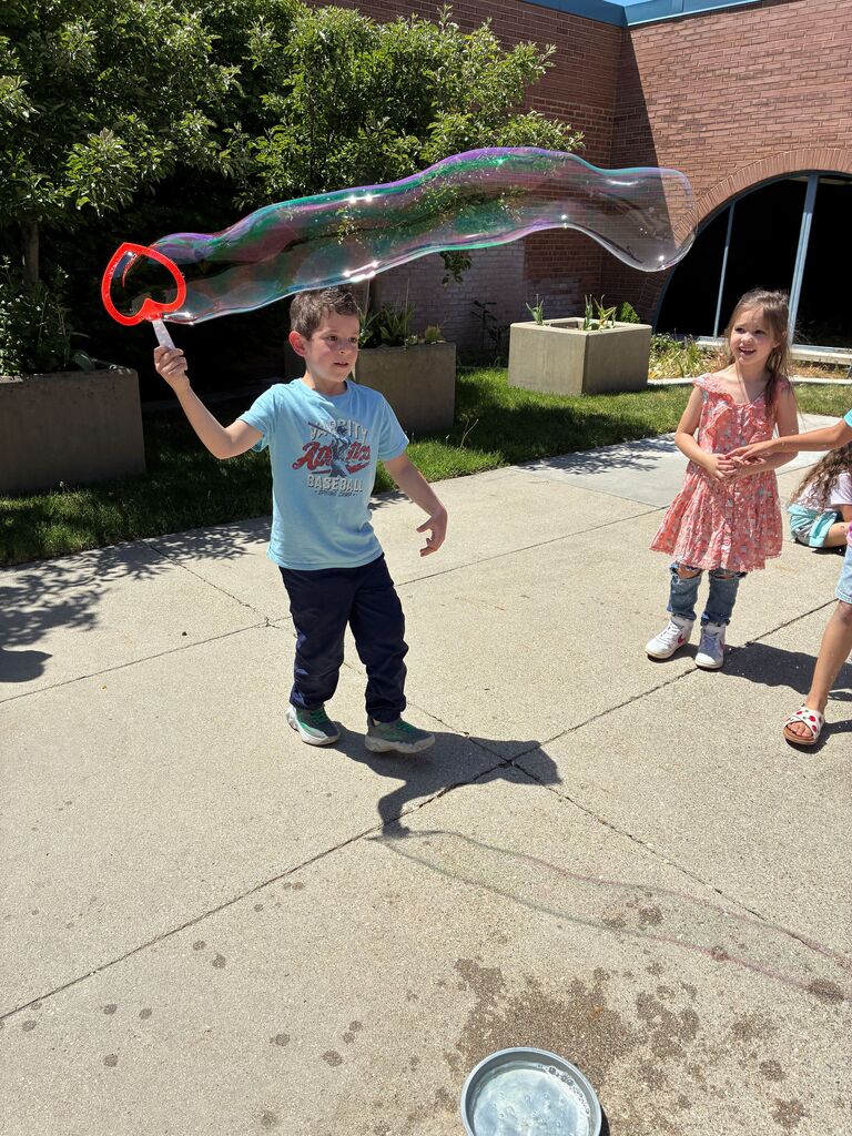 students outside with a giant bubble
